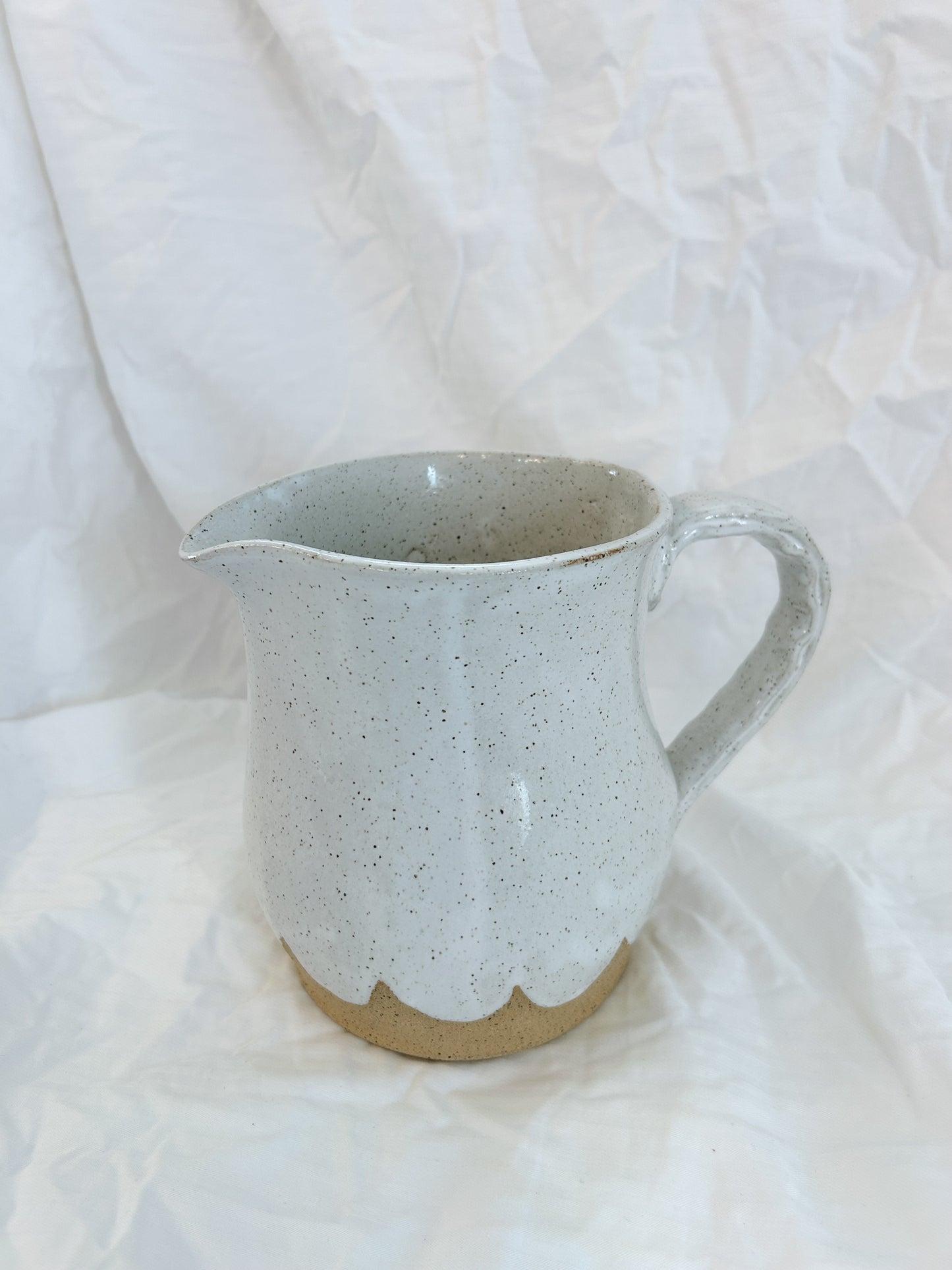 Scalloped water pitcher