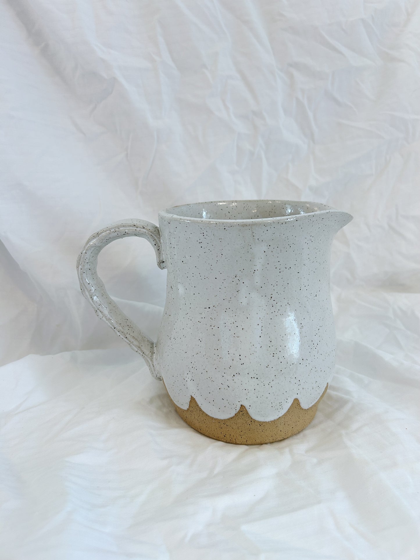 Scalloped water pitcher
