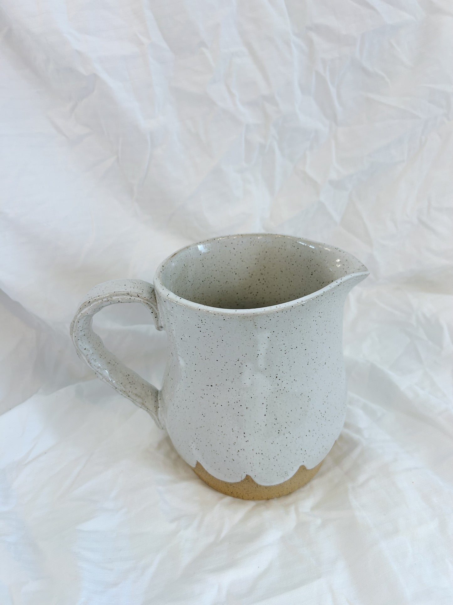 Scalloped water pitcher